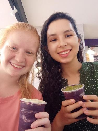 Alyssa and Sister Perri enjoy cups of acai at a restaurant