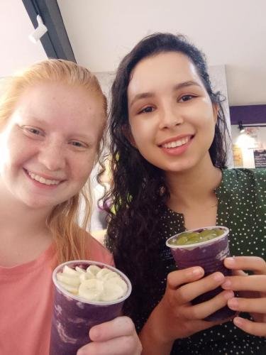 Alyssa and Sister Perri enjoy cups of acai at a restaurant