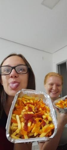 Alyssa and Sister Leopoldes with pans full of french fries