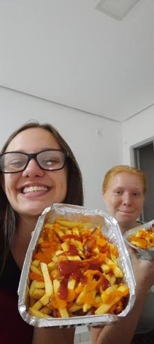 Alyssa and Sister Leopoldes with pans full of french fries