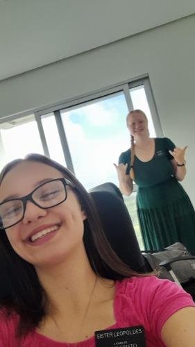 Alyssa behind Sister Leopoldes giving a hang loose sign