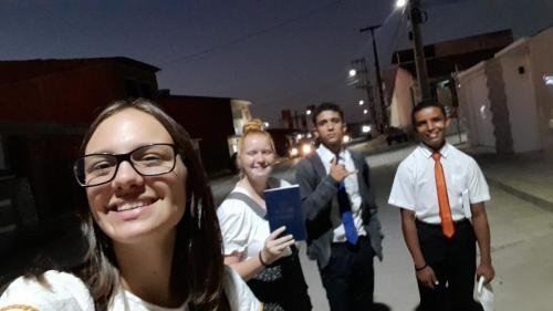 Alyssa and Sister Leopoldes with a Book of Mormon and two future missionaries