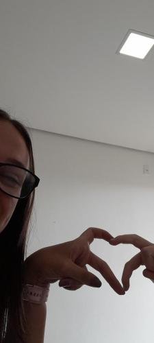 Alyssa and Sister Leopoldes make heart fingers together