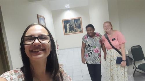 Alyssa and Sister Leopoldes in the hallway with a Bom Conselho ward member