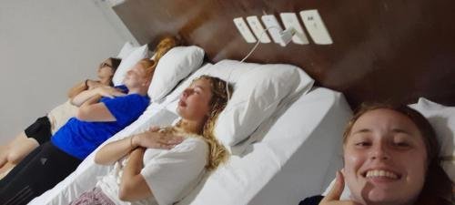 All four sisters in their hotel beds the night before Zone Conference3