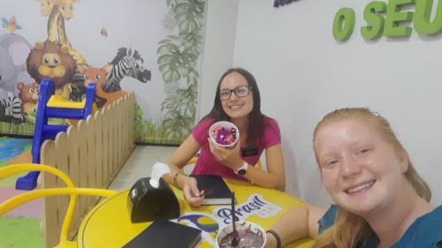 Alyssa and Sister Leopoldes with Acai Bowls in a Restaurant