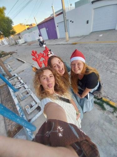 Alyssa with Sisters Fuller and Brewer take a selfie on the street