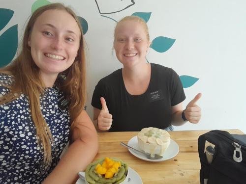 Alyssa and Sister Fuller enjoy some fruit in a restaurant