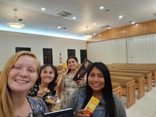 Alyssa and the sisters from her zone in the chapel with treats
