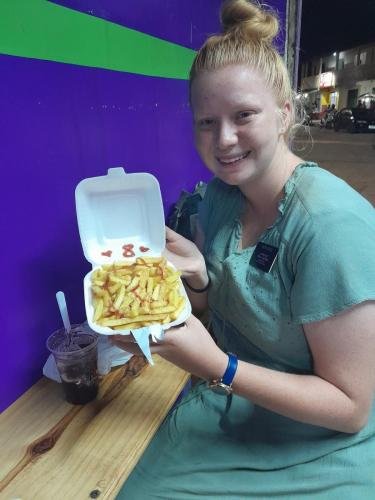 Alyssa with fries to celebrate 8 months in the field