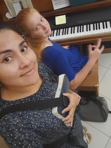 A selfie of Alyssa and Sister Zurita by a piano