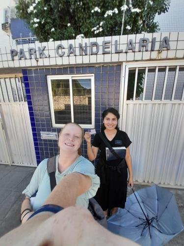 Alyssa and Sister Zurita in front of a Park Candelaria sign and building