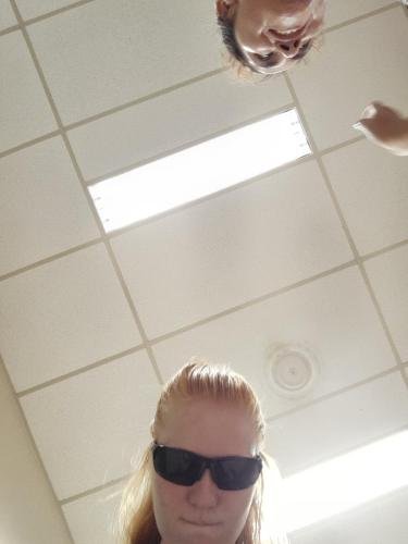 Alyssa takes a selfie while wearing her sunglasses indoors