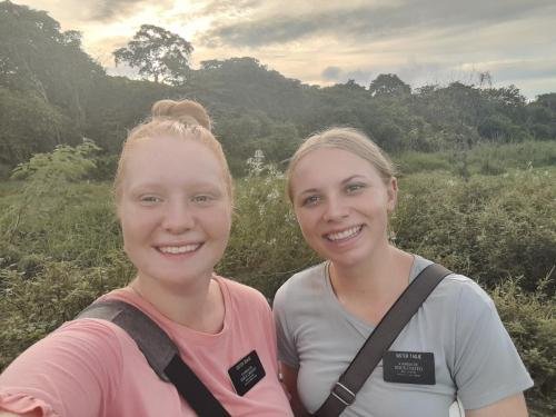 Alyssa and Sister Tadje near a field and trees