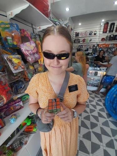 Sister Fisher in the toy store with sunglasses and a Rubik's Cube