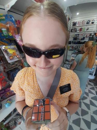 Sister Fisher in the toy store with sunglasses and a Rubik's Cube