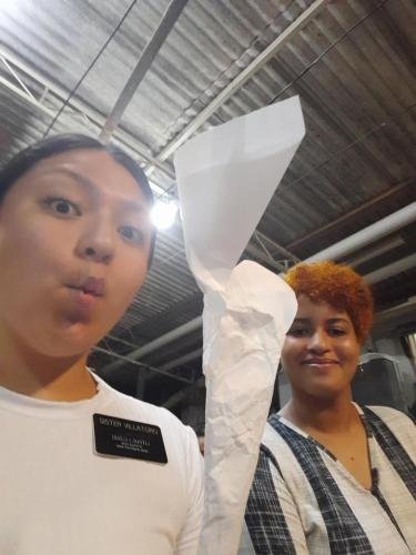 Sister Villatoro makes a face while holding something in paper