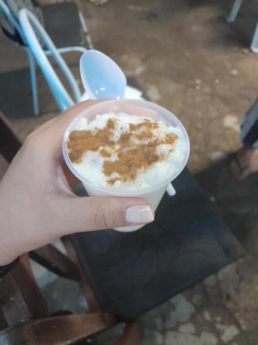 Alyssa holds a cup full of some kind of pudding