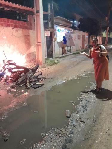 Sister Villatoro points at the fire in the street