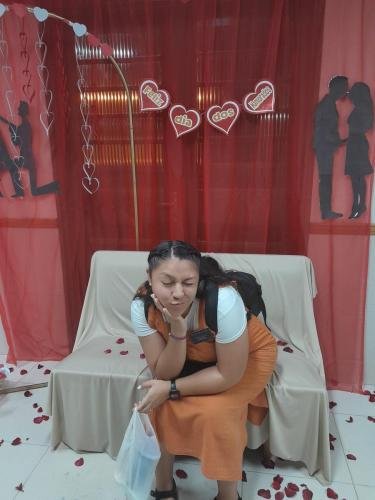 Sister Villatoro on the bench in front of the decorations about Day of Lovers