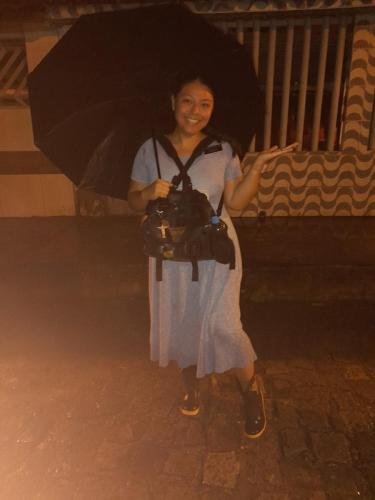Sister Villatoro does a dance with her boots and umbrella in the street