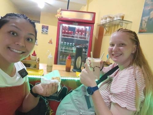 Alyssa and Sister Villatoro enjoying some food at a restaurant