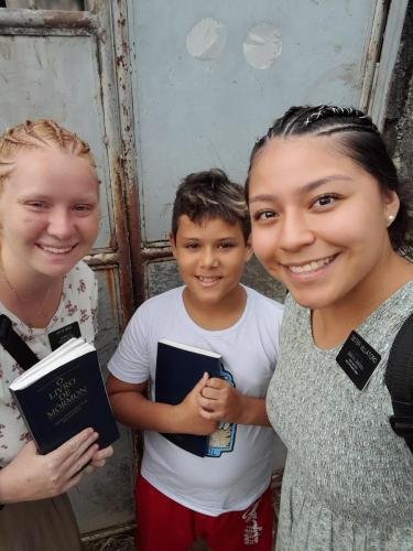 Alyssa and Sister Villatoro with a boy in the street