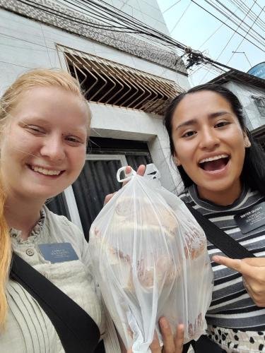 Alyssa and Sister Quispe with a bag of food.