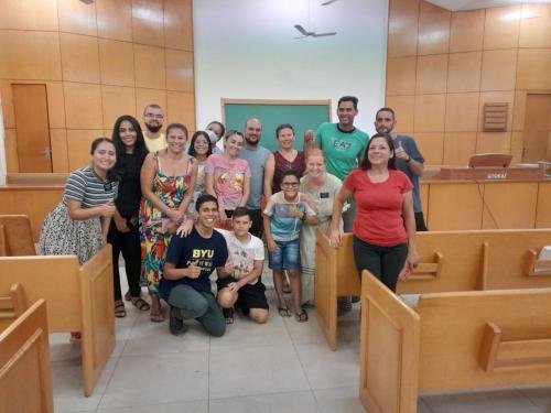 Alyssa and Sister Quispe with a group of members in the chapel