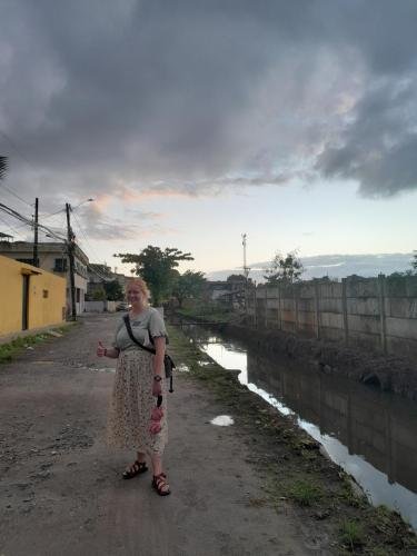 Alyssa gives a big thumbs up standing on a dirt road