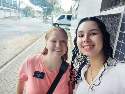 Alyssa and Sister Perri find a spot out of the rain