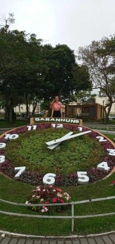 Alyssa by a large, flower clock in Garanhuns