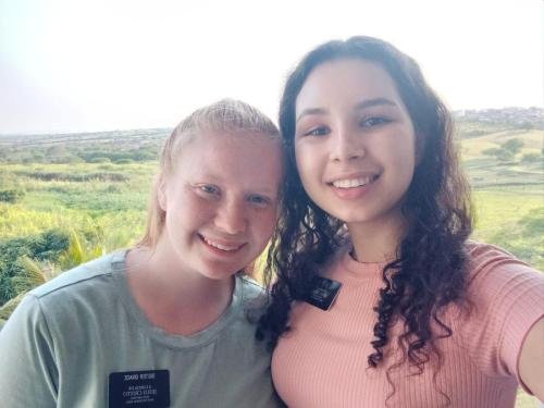 Alyssa and Sister Perri in a selfie in front of the fields of Bom Conselho