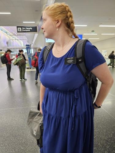 Alyssa turns to board the plane taking her to her mission