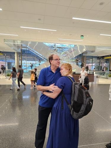 Alyssa hugs dad before she boards the plane for her mission