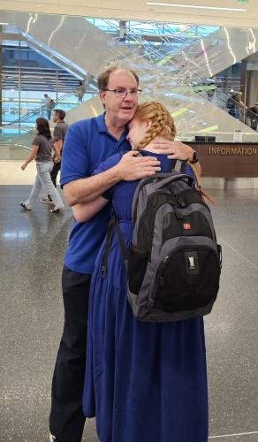 Alyssa hugs dad before she boards the plane for her mission