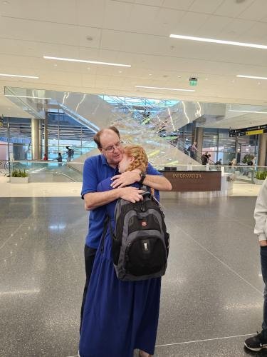 Alyssa hugs dad before she boards the plane for her mission