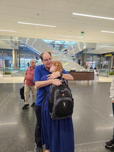 Alyssa hugs dad before she boards the plane for her mission