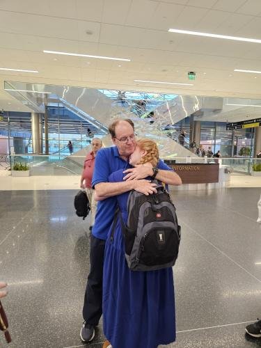 Alyssa hugs dad before she boards the plane for her mission