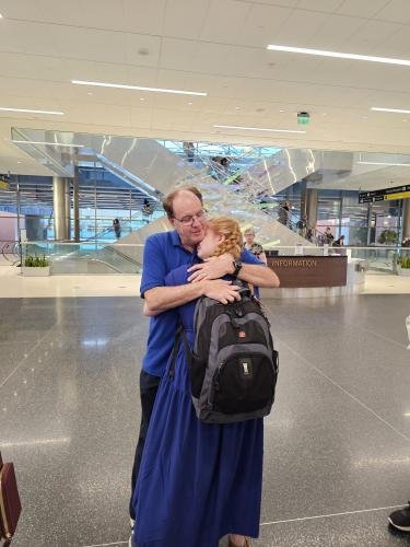 Alyssa hugs dad before she boards the plane for her mission