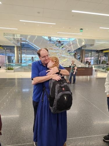 Alyssa hugs dad before she boards the plane for her mission