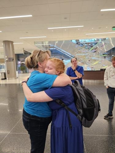 Alyssa gives mom a big hug before boarding the airplane for her mission