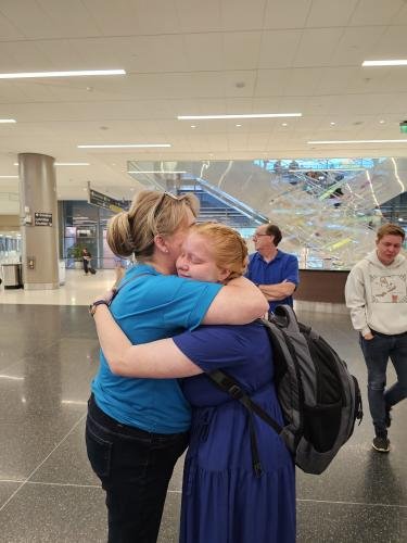 Alyssa gives mom a big hug before boarding the airplane for her mission