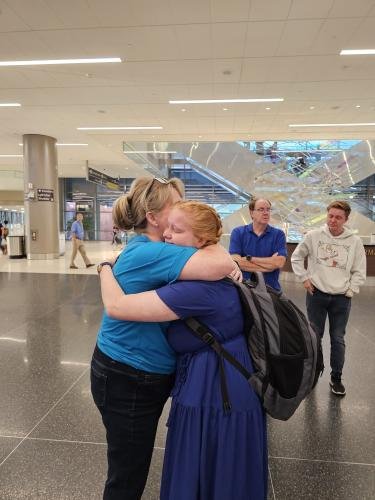 Alyssa gives mom a big hug before boarding the airplane for her mission