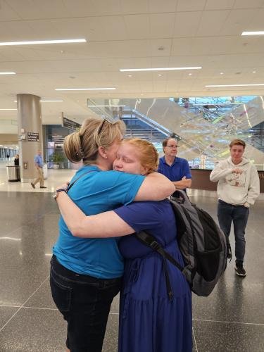Alyssa gives mom a big hug before boarding the airplane for her mission