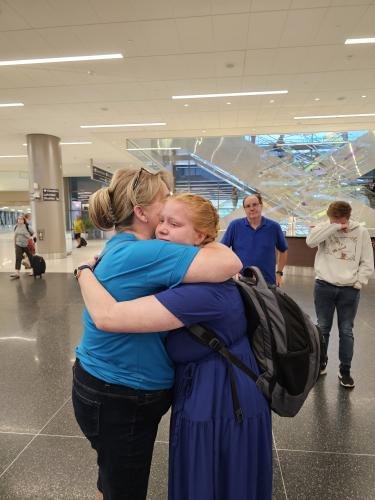 Alyssa gives mom a big hug before boarding the airplane for her mission