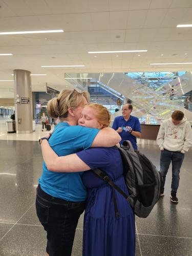 Alyssa gives mom a big hug before boarding the airplane for her mission