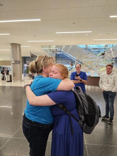 Alyssa gives mom a big hug before boarding the airplane for her mission