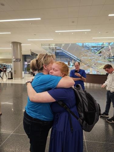 Alyssa gives mom a big hug before boarding the airplane for her mission