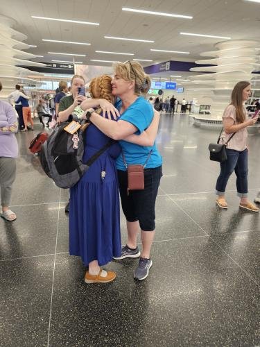 Alyssa gives mom a big hug before boarding the airplane for her mission